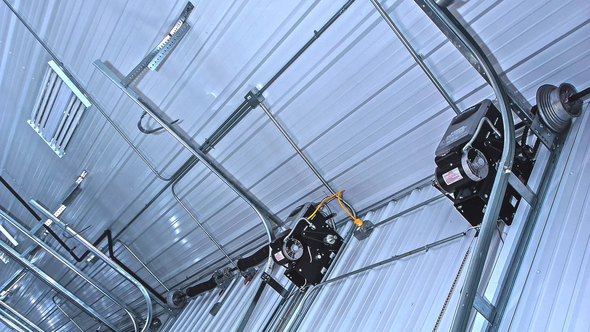 Interior of a commercial garage with two commercial garage door opener/operator units