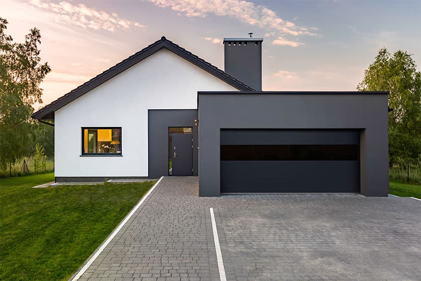 Suburban home with a contemporary aluminum full-view garage door in black from PDQ Doors
